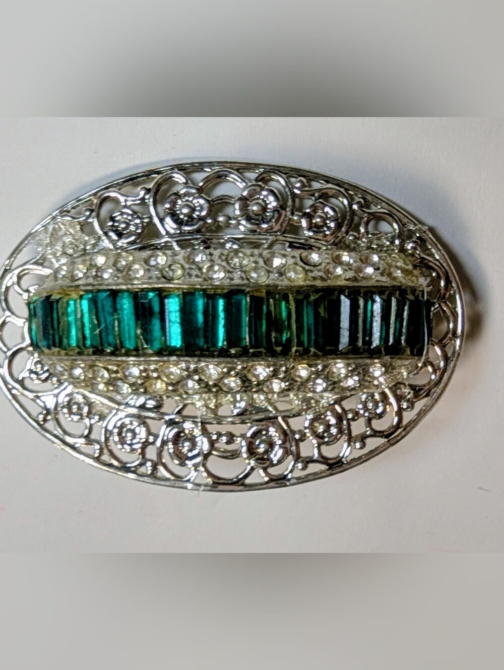Wendy Gell pin silver filigree brick base with Emerald baguette shape.